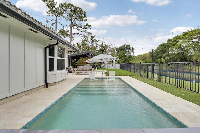 view of pool featuring a yard, a patio area, a fenced backyard, and a fenced in pool