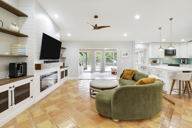 living room featuring french doors, light tile patterned floors, recessed lighting, a ceiling fan, and vaulted ceiling