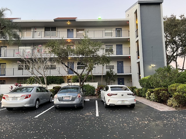 view of building exterior featuring uncovered parking