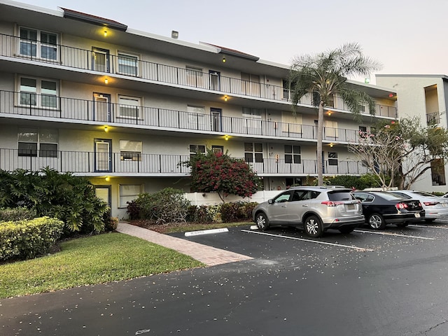 view of property featuring uncovered parking