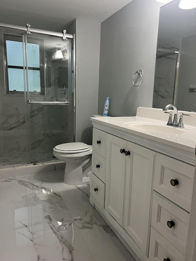 bathroom featuring a marble finish shower, marble finish floor, vanity, and toilet