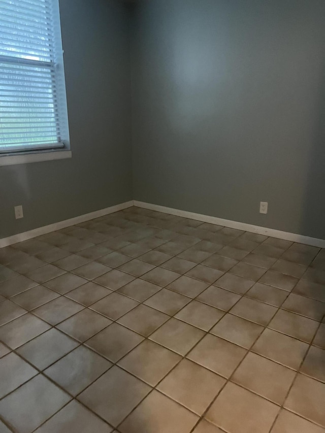 spare room featuring baseboards