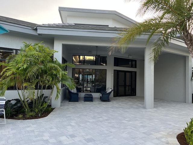 doorway to property featuring french doors and stucco siding