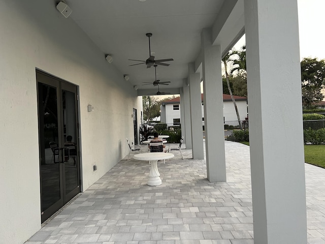 view of patio / terrace featuring ceiling fan and fence