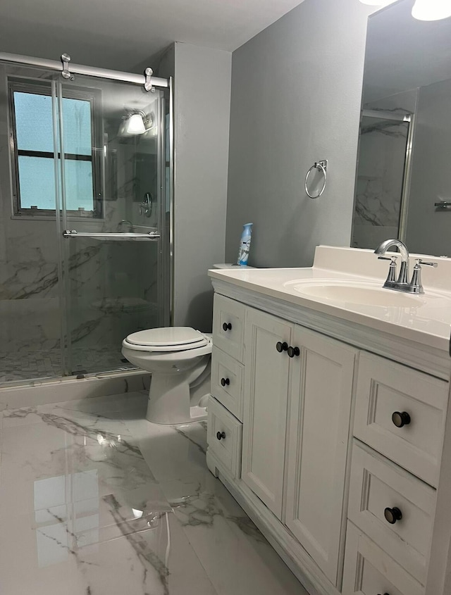 bathroom with a marble finish shower, marble finish floor, vanity, and toilet