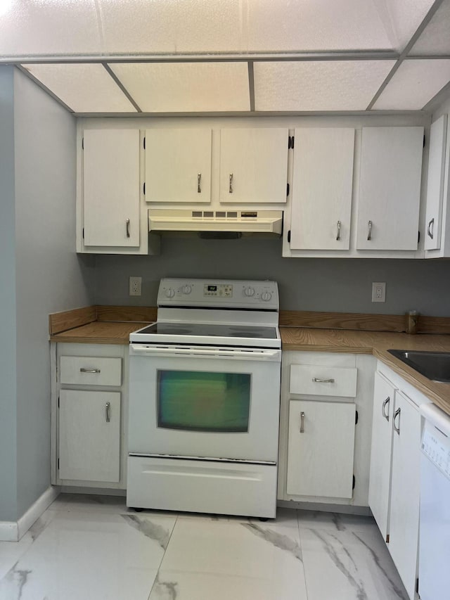 kitchen with marble finish floor, a sink, white appliances, under cabinet range hood, and baseboards