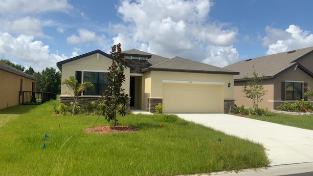 view of front facade featuring driveway, a garage, stone siding, a front lawn, and stucco siding