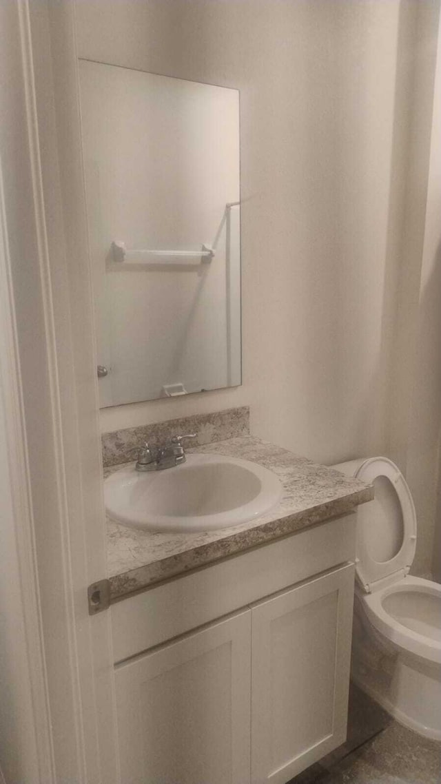 6259 NW Regent St, Port Saint Lucie, FL 34983 - bathroom featuring vanity and toilet