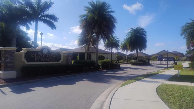 6259 NW Regent St, Port Saint Lucie, FL 34983 - view of street featuring street lighting, curbs, and sidewalks