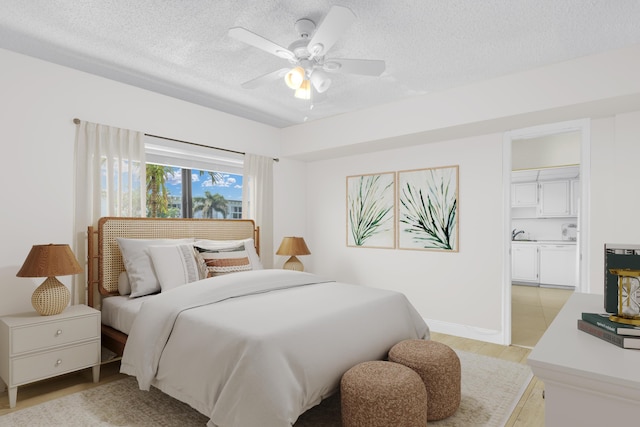 bedroom featuring light wood-style flooring, a ceiling fan, and a textured ceiling