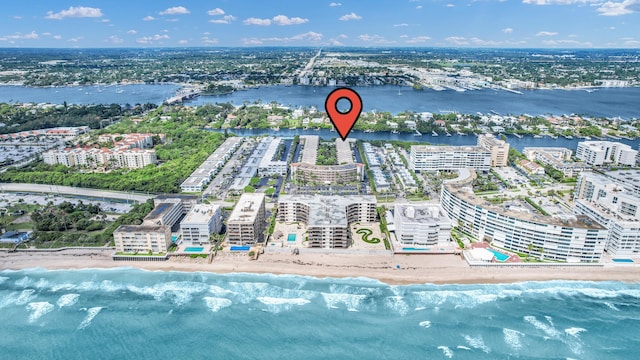 drone / aerial view with a beach view, a water view, and a city view