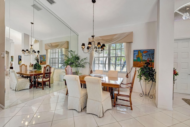 dining room with a healthy amount of sunlight, a chandelier, and light tile patterned flooring