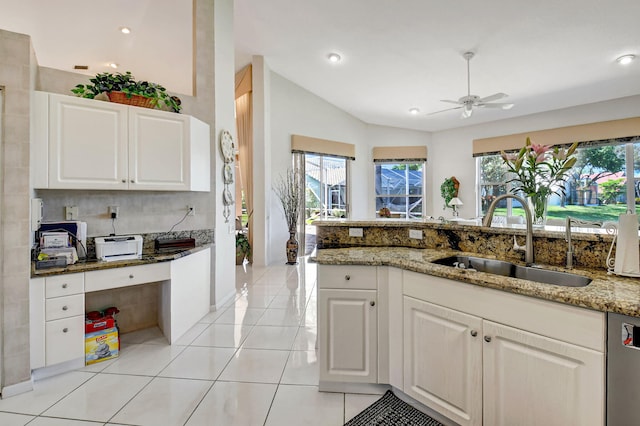 kitchen with light stone countertops, dishwasher, plenty of natural light, and a sink