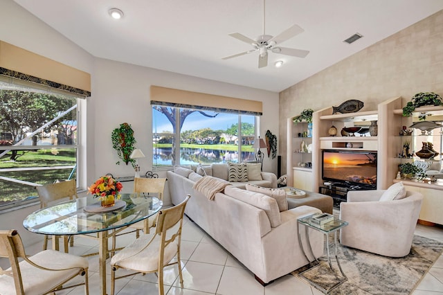 living area with high vaulted ceiling, visible vents, ceiling fan, and light tile patterned floors