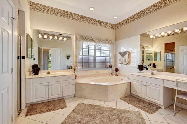 full bath with a garden tub, a sink, and tile patterned floors