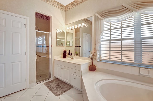 full bathroom featuring a stall shower, a garden tub, a wealth of natural light, and tile patterned floors