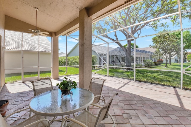 unfurnished sunroom with vaulted ceiling and ceiling fan