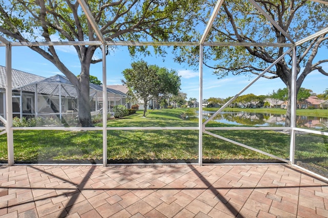 unfurnished sunroom featuring a water view