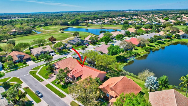 bird's eye view featuring view of golf course, a water view, and a residential view