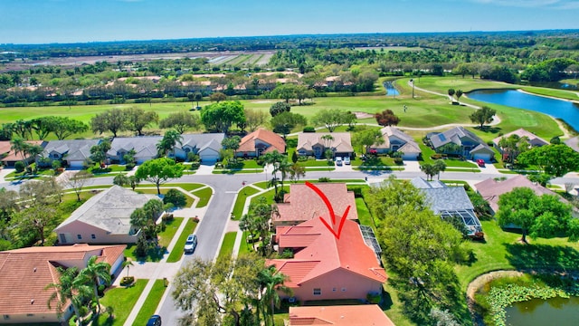 birds eye view of property featuring a water view, view of golf course, and a residential view