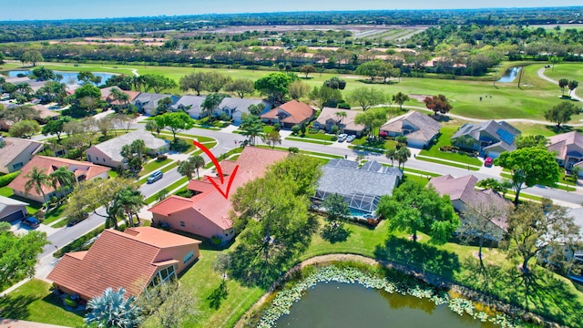 drone / aerial view featuring a residential view, a water view, and golf course view