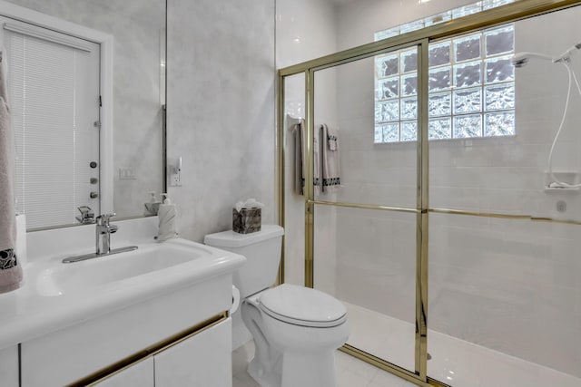 bathroom featuring vanity, a shower stall, and toilet