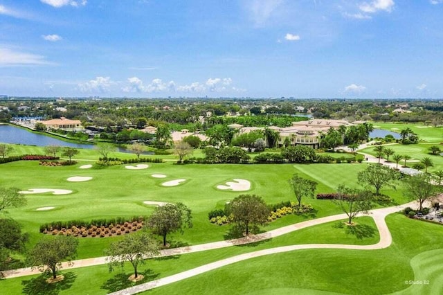 drone / aerial view with golf course view and a water view