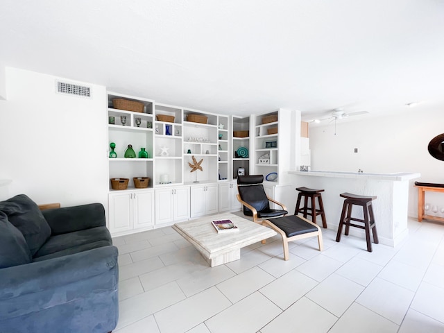 living room featuring visible vents and a ceiling fan