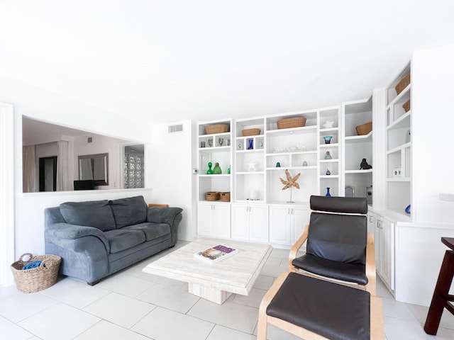 living area with visible vents and light tile patterned floors