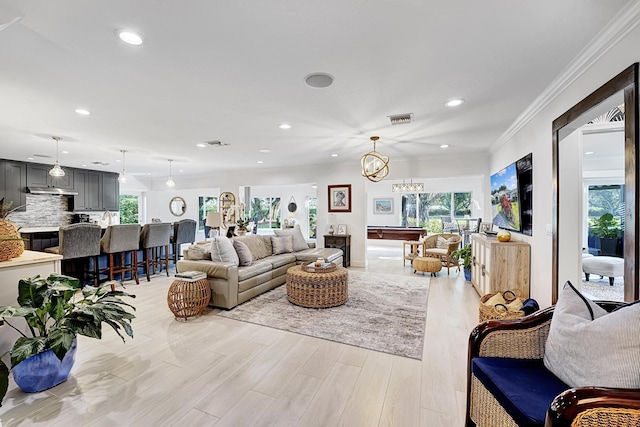 living room featuring ornamental molding, a wealth of natural light, visible vents, and recessed lighting