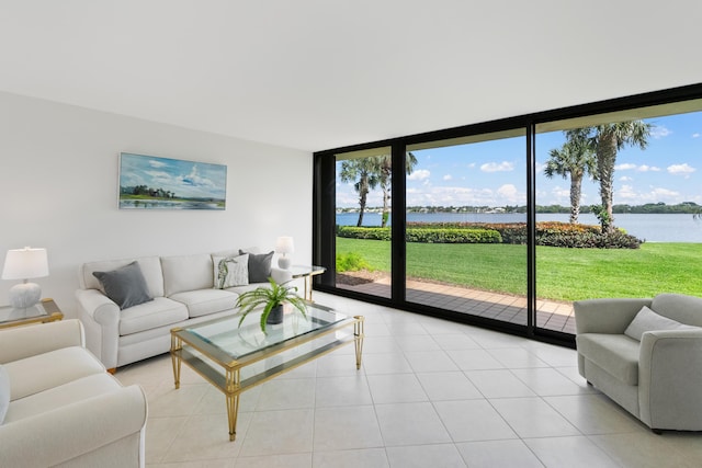 living room with a water view, expansive windows, and light tile patterned flooring