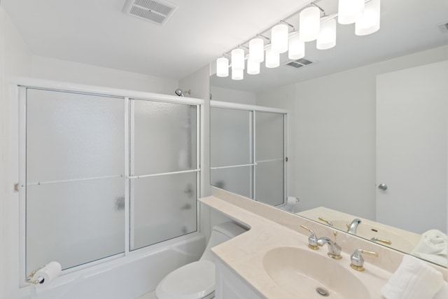 bathroom with visible vents, shower / bath combination with glass door, vanity, and toilet