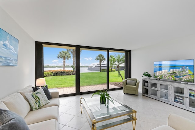 living room with floor to ceiling windows and light tile patterned floors