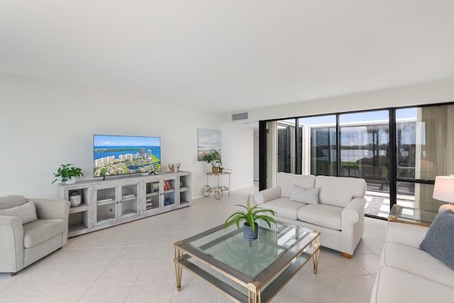 living room featuring light tile patterned floors and visible vents