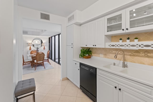 kitchen featuring light tile patterned flooring, visible vents, white cabinetry, dishwasher, and tasteful backsplash