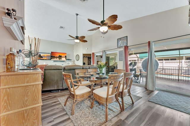 dining area featuring visible vents, light wood-style flooring, and a wealth of natural light