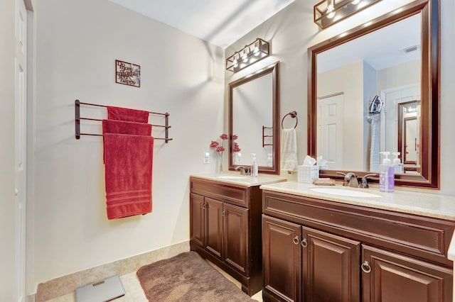 full bathroom featuring double vanity, visible vents, a sink, and tile patterned floors