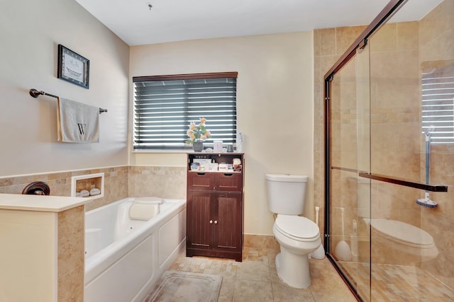 bathroom with a garden tub, tile patterned flooring, a shower stall, and toilet