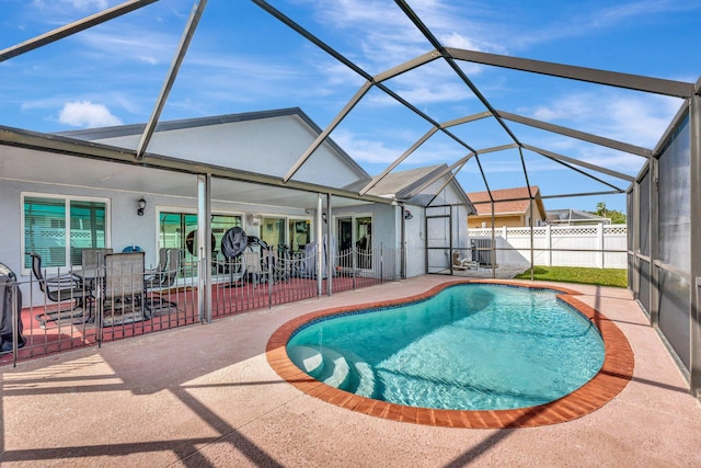 view of swimming pool with a fenced in pool, a lanai, a patio area, and fence