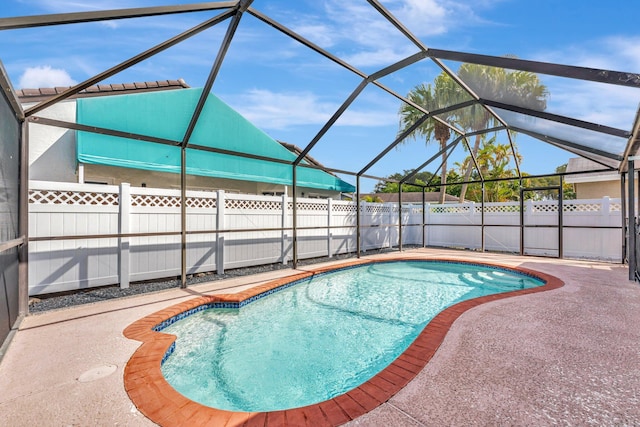 view of swimming pool featuring a fenced in pool, glass enclosure, a fenced backyard, and a patio