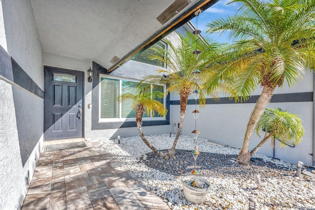 entrance to property with stucco siding