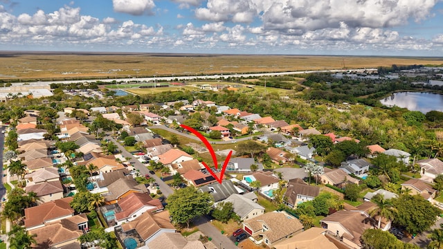 birds eye view of property featuring a residential view and a water view