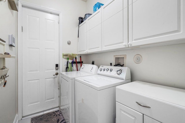 clothes washing area with cabinet space and independent washer and dryer