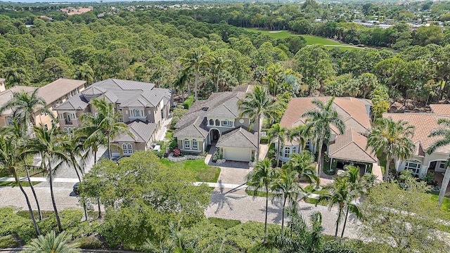 drone / aerial view featuring a residential view and a wooded view