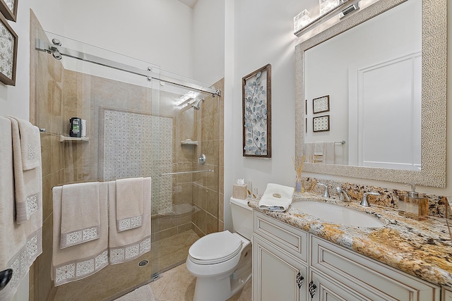 bathroom featuring a stall shower, tile patterned flooring, vanity, and toilet