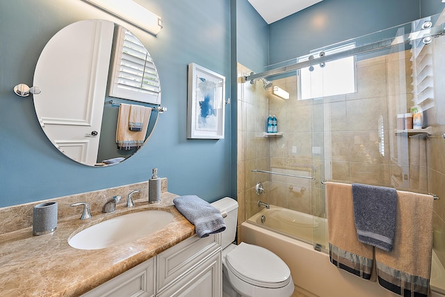 bathroom with toilet, shower / bath combination with glass door, and vanity