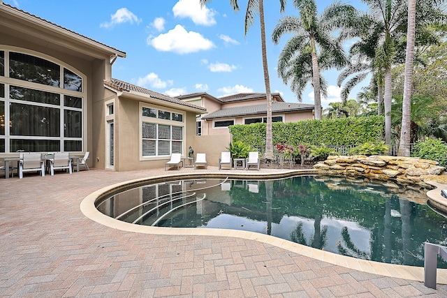 view of swimming pool featuring a patio area and a fenced in pool