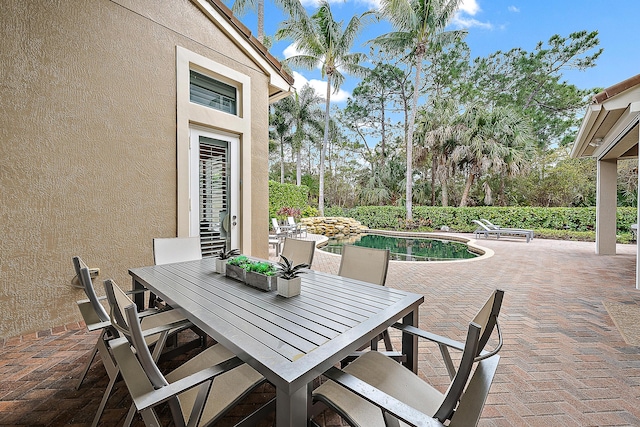 view of patio / terrace featuring outdoor dining space and a fenced in pool