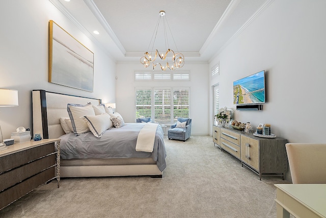 carpeted bedroom featuring ornamental molding, a tray ceiling, a chandelier, and baseboards