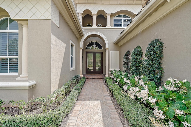 property entrance featuring french doors and stucco siding